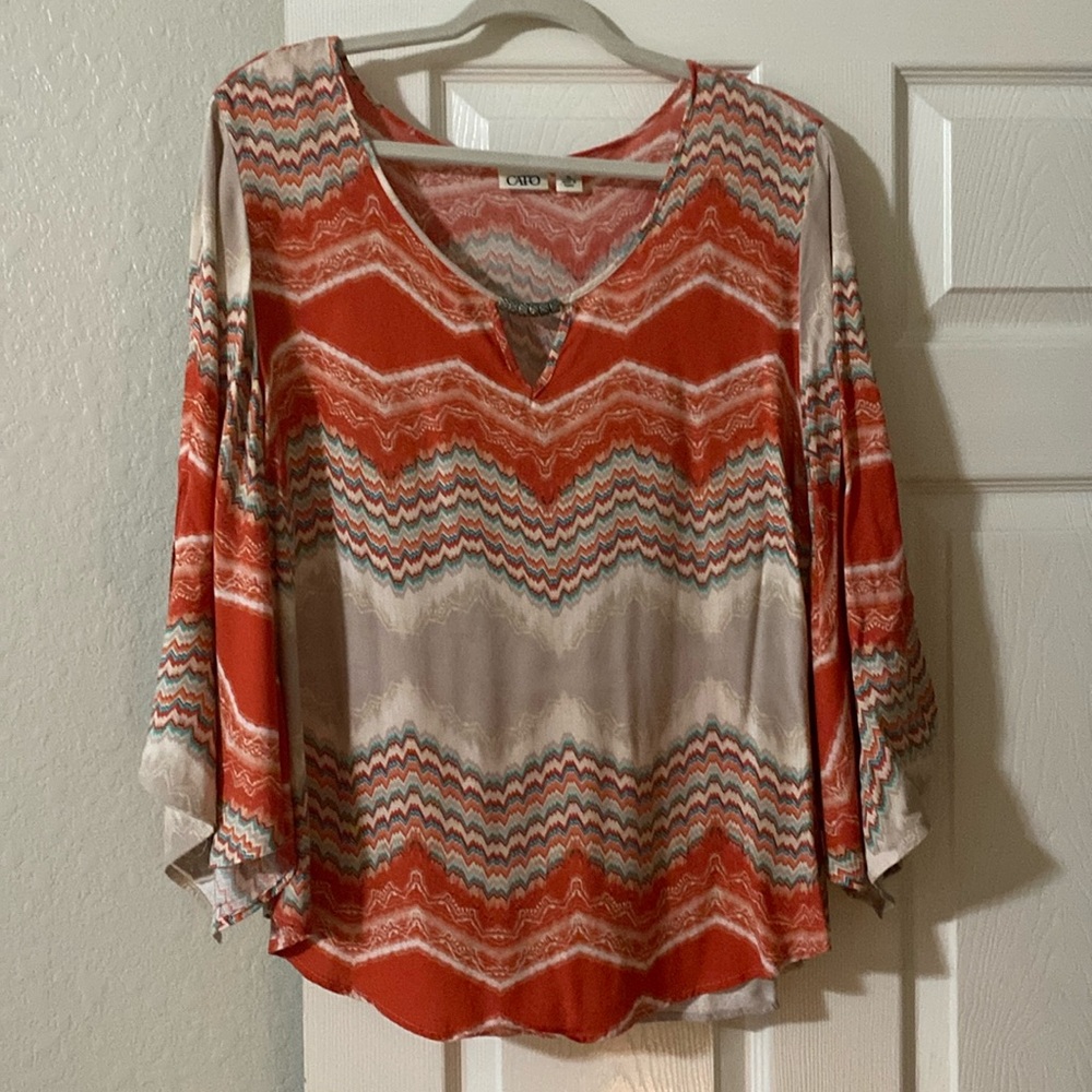 Women’s top with metal accents and three-quarter sleeve